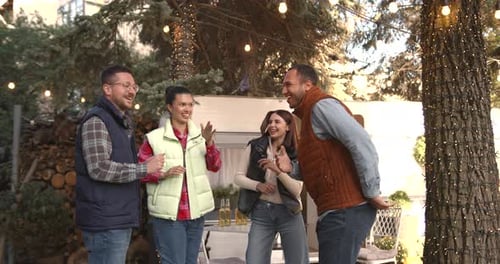 Friends Enjoying Time Together Near a Camper