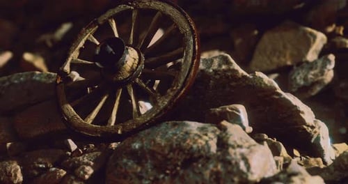 Old Wooden Wagon Wheel on Rustic Rocks Time Lapse