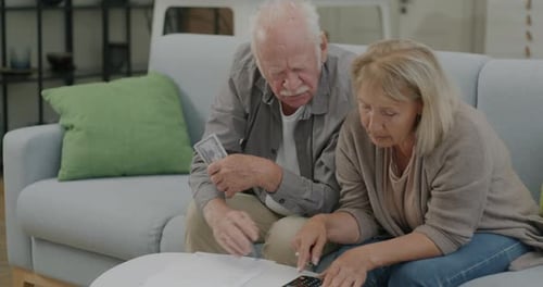 Senior Couple Reviewing Finances at Home