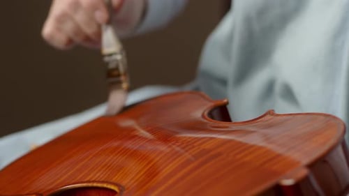 Applying Varnish to a Violin with a Brush