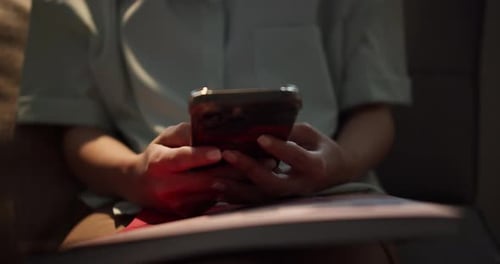 User engaging with mobile device indoor setting lifestyle content close-up view technology concept