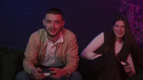 Young Couple Playing Video Games Together on Couch