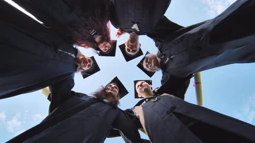 College Graduates Embrace in a Circle