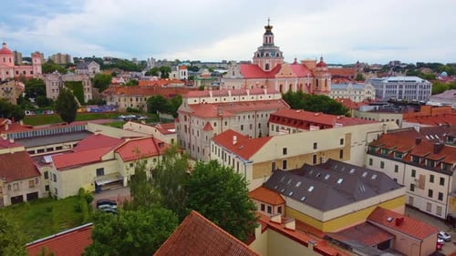 Aerial view of Vilnius, Lithuania, showcasing historic old town buildings and rooftops under a cloud