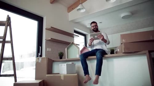 A Mature Man with Tablet Planning When Moving in New Home. Slow