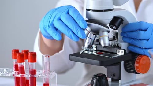 Close Up Scientist Using Microscope for Blood Analysis