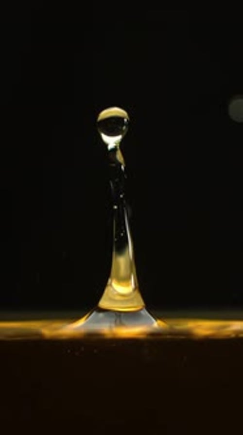 Golden Liquid Drop Impacts Surface in Slow Motion
