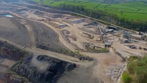 Aerial drone shot of quarry with roads and tracks in Summer