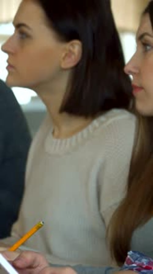 Focused Female Students Engaged in a Lively Lecture