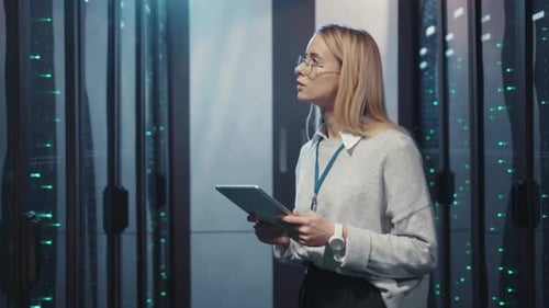 Woman Uses Tablet in Data Center Server Room