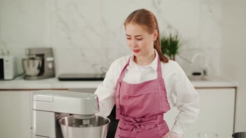 Woman Uses Stand Mixer in Modern Kitchen