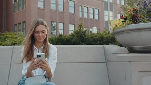 Young Woman Using Smartphone in Urban Setting