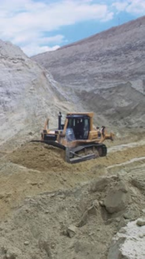 Tracked Vehicle Carving Curves Into Sandy Hillside Bulldozer Smoothly Pushes Sand to Create Access