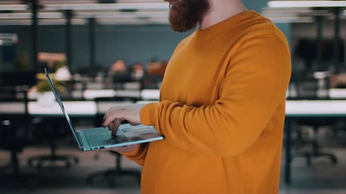 Person Using Laptop in Office Setting During Daytime Work Hours