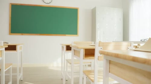 Empty Classroom with Desks and Chalkboard