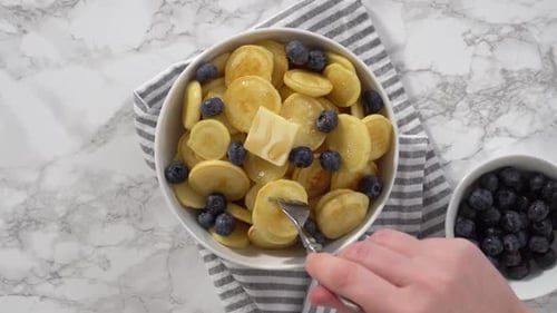 Pancake Cereal Garnished with Blueberries and Butter