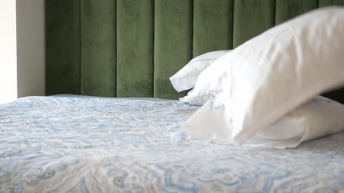 Making Bed with Pillows in Bright Bedroom