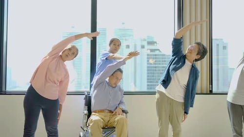 Seniors Doing Chair Yoga Exercises with Nurse