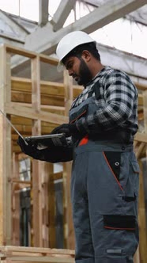 Indian Engineer Reviewing SIP Panel House Construction Plans