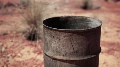 Old Empty Rusted Barrel on Sand