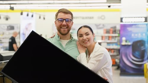 Happy Couple with New Tv in Tech Store