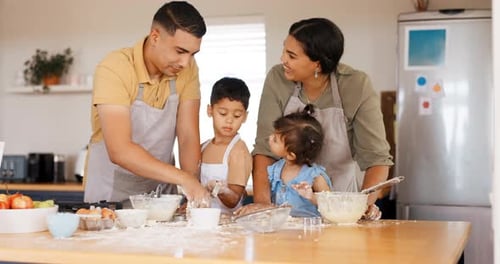 Family Baking Together in Kitchen Having Fun
