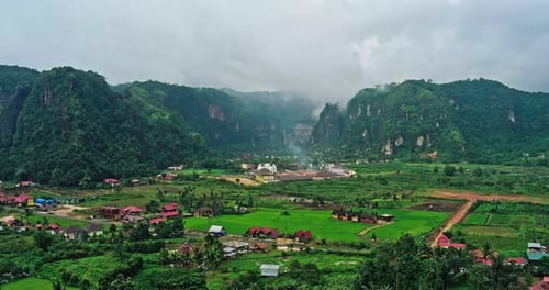 Aerial view panorama of the village with a cliff background