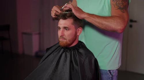 Man Getting a Haircut at a Modern Barbershop