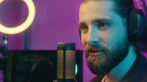 Carefree Smiling Glad Caucasian Male Guy Blogger Streamer Host Addict Touch Microphone Stream Radio