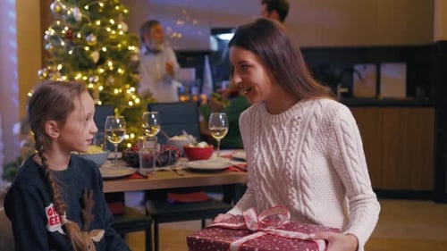 Festive Family Celebrates Christmas Exchanging Gifts at Home