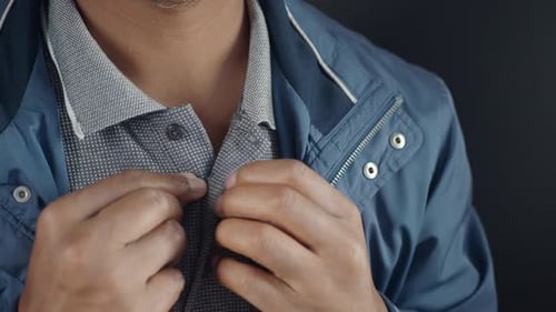 Man Buttoning His Shirt Close Up