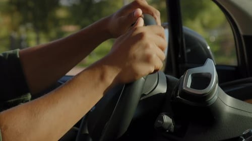 Hands on Car Steering Wheel Driving in City