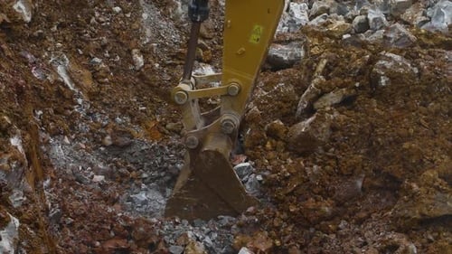 Excavator Digging Earth and Rocks