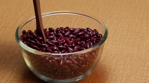 Bowl of Kidney Beans Stirred with Wooden Spoon