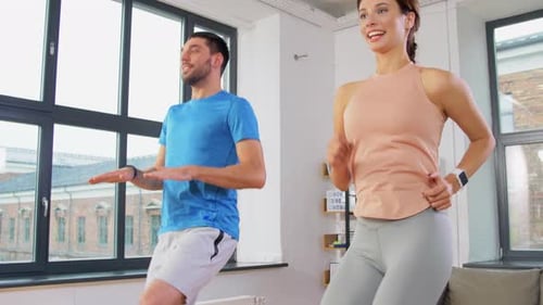 Sport, Fitness, Lifestyle and People Concept - Smiling Man and Woman Exercising