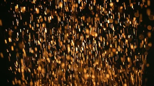 Golden Falling Sparks Against a Dark Background