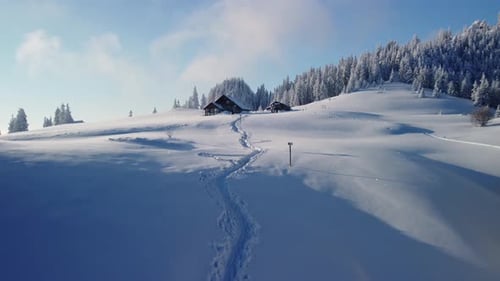 Experience the enchantment of a winter cabin atop a snow-covered mountain, a captivating hideaway am