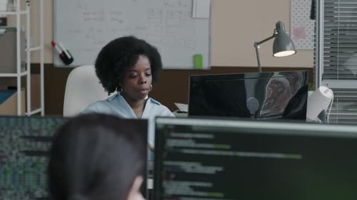 Black Woman Working on Desktop Computer in Office