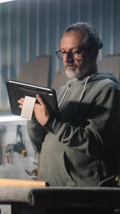Man Using Tablet in Workshop