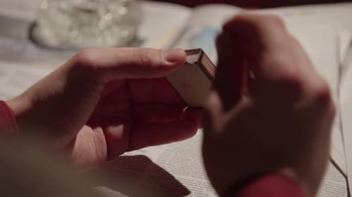 Hands Strike Match on Box