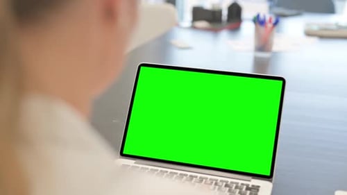 Woman Using Laptop with Green Screen