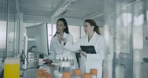 Women Scientists Analyzing Data on Computer in Laboratory