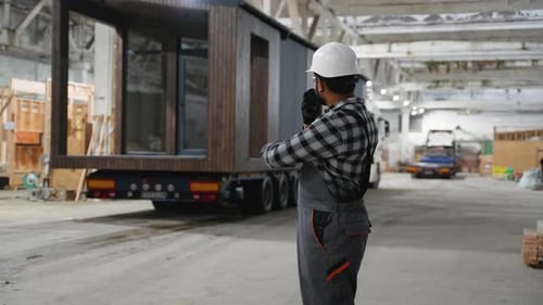 Indian Worker Directing Modular Home Transportation Process