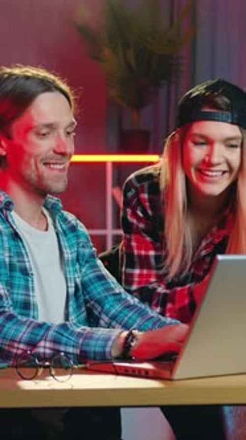 Happy Couple Using Laptop Together at Home