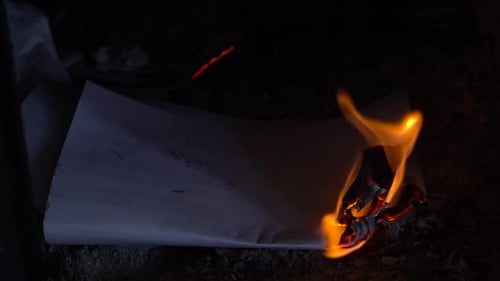 Close-up of Flames Burning White Paper