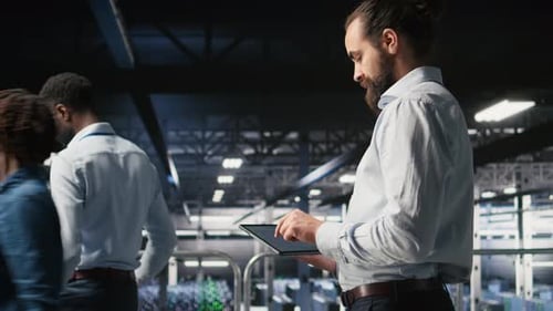 Programmers on Data Center Industrial Platform Checking Code on Tablet