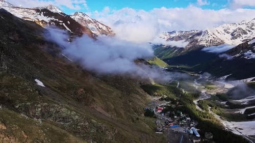 Mesmerizing View of Mountains with Greenery Slopes Village Snowcapped Peaks