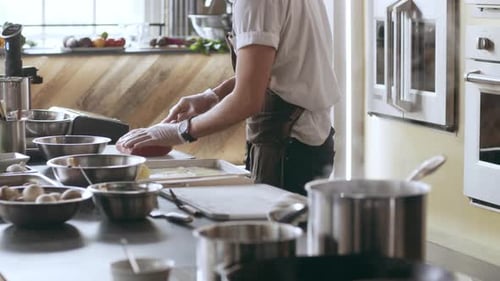 Chef Preparing Raw Meat on Cutting Board in Kitchen