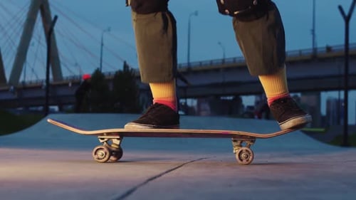 Skateboarder in Colorful Socks Riding and Making Trick