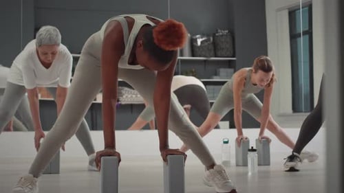Multiethnic Group of Women Stretching in Studio